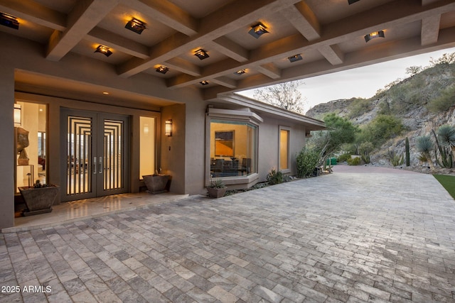 view of patio / terrace with a mountain view and french doors