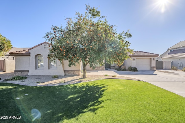 mediterranean / spanish-style house featuring a garage and a front lawn