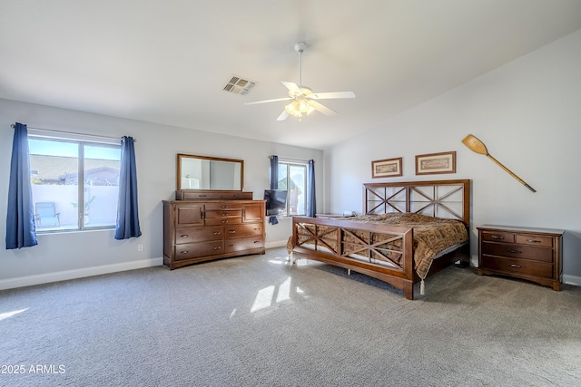 carpeted bedroom featuring multiple windows, lofted ceiling, and ceiling fan