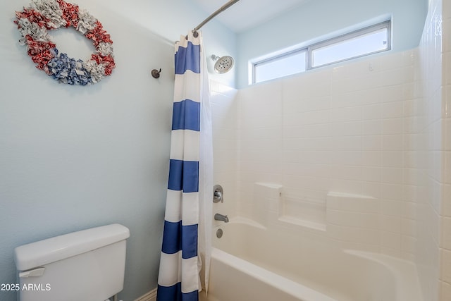 bathroom featuring shower / tub combo with curtain and toilet