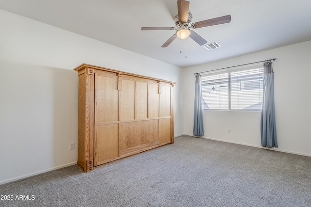 unfurnished bedroom with light colored carpet and ceiling fan