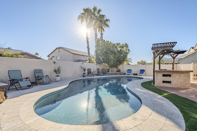 view of swimming pool featuring a bar and a patio