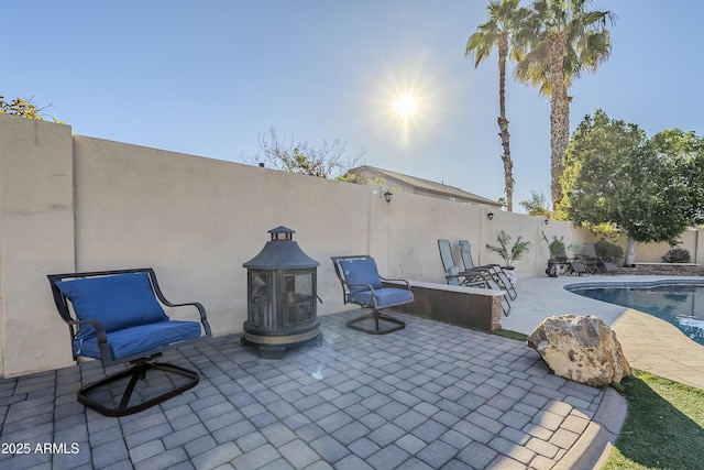 view of patio / terrace with a fenced in pool