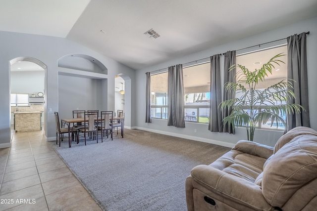 tiled living room with vaulted ceiling