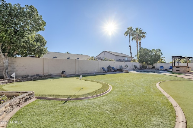 view of yard with a fenced in pool and a pergola