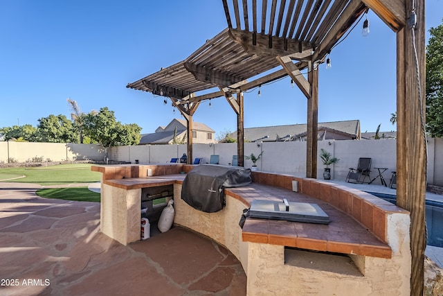 view of patio with area for grilling, a pergola, exterior kitchen, and an outdoor bar