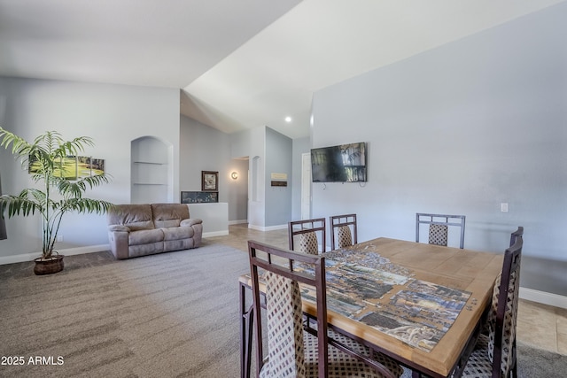 dining area with built in shelves and lofted ceiling