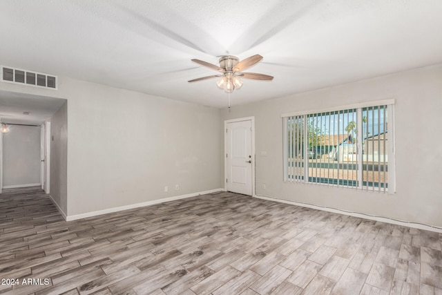 empty room with light hardwood / wood-style floors and ceiling fan