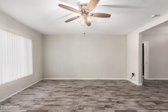 empty room with hardwood / wood-style flooring and ceiling fan