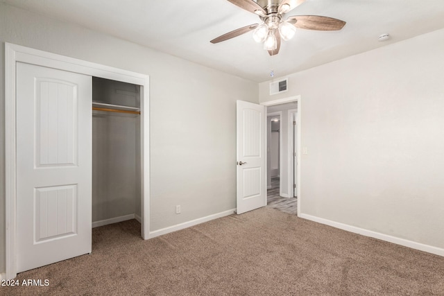 unfurnished bedroom featuring ceiling fan, a closet, and carpet