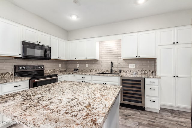 kitchen with white cabinetry, wine cooler, electric range, and sink