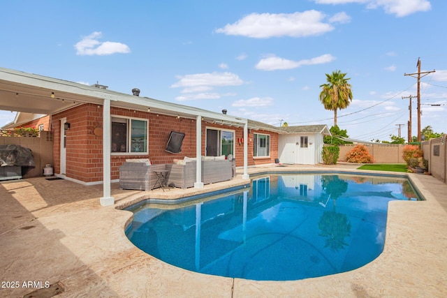 view of swimming pool with outdoor lounge area, a patio, a fenced backyard, and a fenced in pool