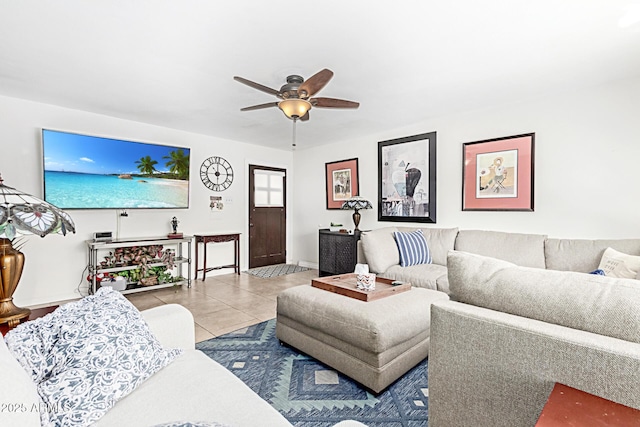 living room featuring ceiling fan, baseboards, and light tile patterned flooring