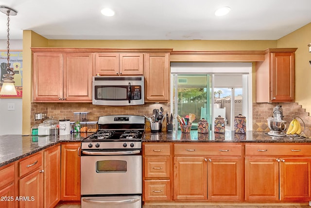 kitchen with decorative backsplash, recessed lighting, appliances with stainless steel finishes, and dark stone counters