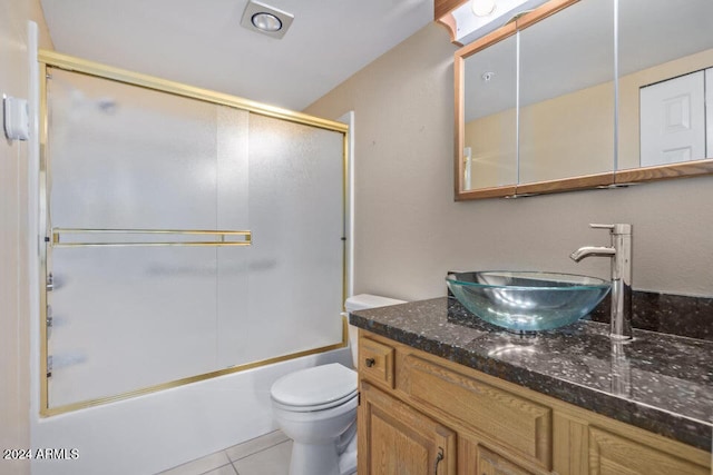 full bathroom featuring vanity, enclosed tub / shower combo, toilet, and tile patterned floors