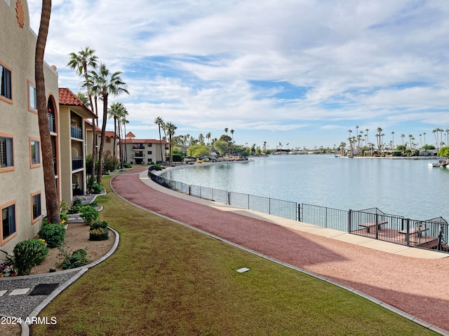 view of community featuring a water view and a lawn