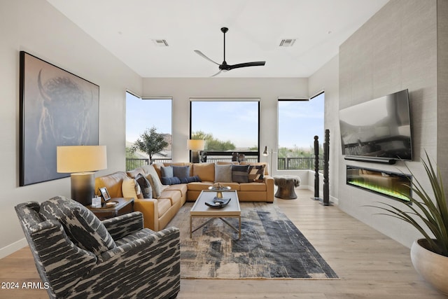 living room featuring ceiling fan and light hardwood / wood-style flooring