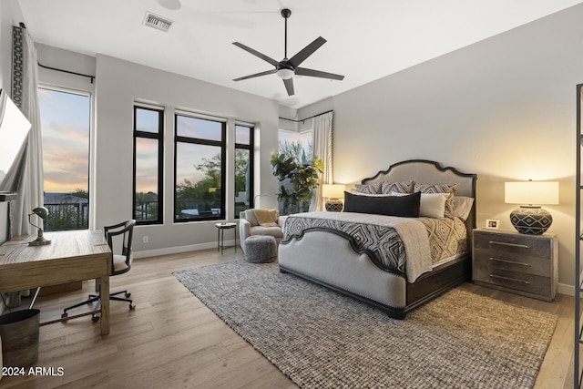 bedroom with ceiling fan and light hardwood / wood-style floors