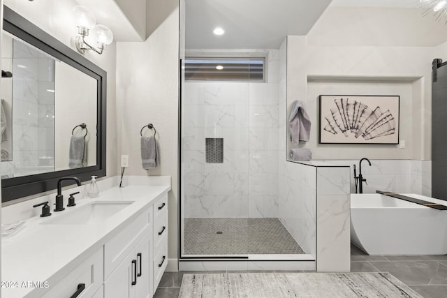 bathroom featuring shower with separate bathtub, vanity, tile walls, and tile patterned floors