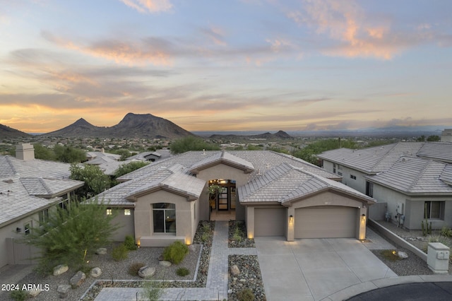 view of front of house with a garage and a mountain view