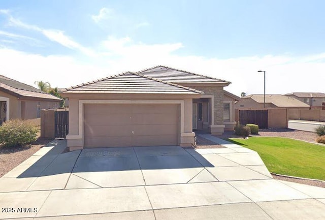 ranch-style house featuring driveway, fence, a tiled roof, and stucco siding