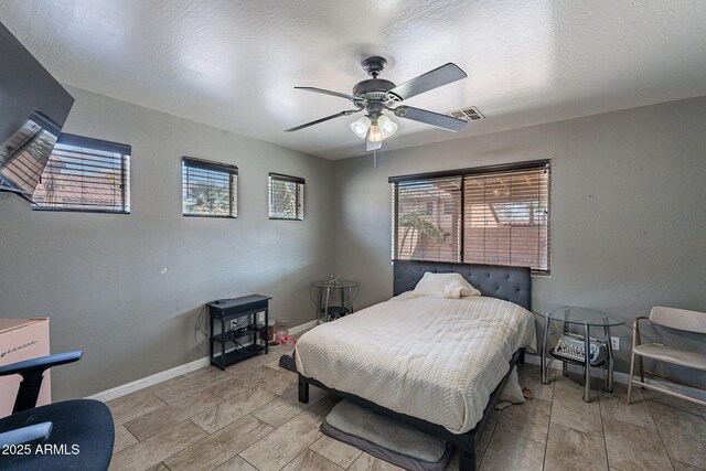 13547 W Peck Dr, Litchfield Park, AZ 85340 - bedroom with multiple windows, a textured wall, and baseboards