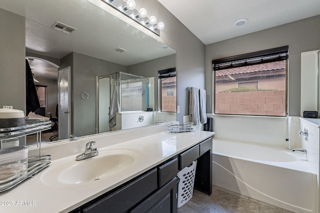 13547 W Peck Dr, Litchfield Park, AZ 85340 - full bathroom with double vanity, visible vents, a stall shower, a sink, and a bath