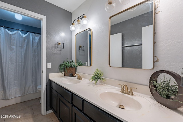 13547 W Peck Dr, Litchfield Park, AZ 85340 - bathroom featuring tile patterned flooring, a sink, toilet, and double vanity