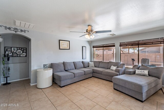 13547 W Peck Dr, Litchfield Park, AZ 85340 - living area featuring arched walkways, ceiling fan, light tile patterned flooring, and visible vents