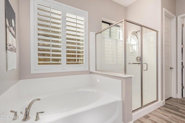 2065 N Red Clf, Mesa, AZ 85207 - bathroom with a bath, a shower stall, and wood finished floors