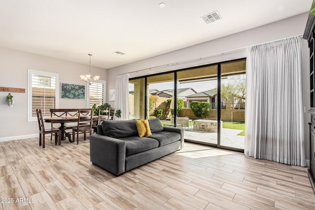 2065 N Red Clf, Mesa, AZ 85207 - living area featuring a chandelier, light wood-style floors, and baseboards