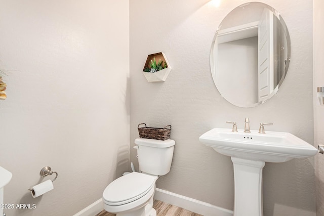 2065 N Red Clf, Mesa, AZ 85207 - half bathroom featuring toilet, wood finished floors, baseboards, and a sink