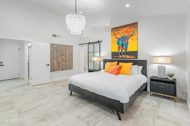 bedroom featuring lofted ceiling, a barn door, and a chandelier