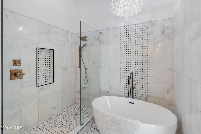 bathroom featuring separate shower and tub and an inviting chandelier