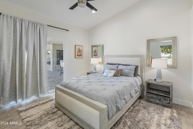 bedroom with high vaulted ceiling, ceiling fan, and wood-type flooring