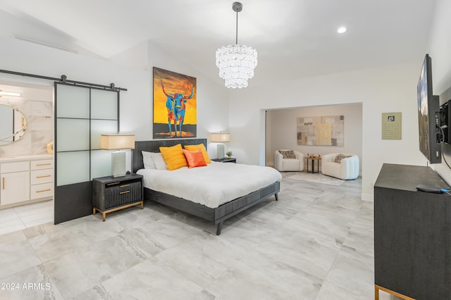 bedroom featuring ensuite bathroom, a notable chandelier, vaulted ceiling, and a barn door