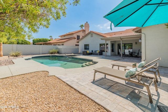 view of pool featuring an outdoor living space and a patio