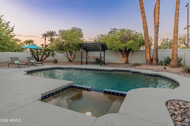 pool at dusk with a pergola and a patio