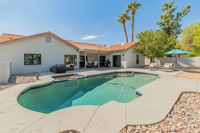 view of pool with a patio and an in ground hot tub