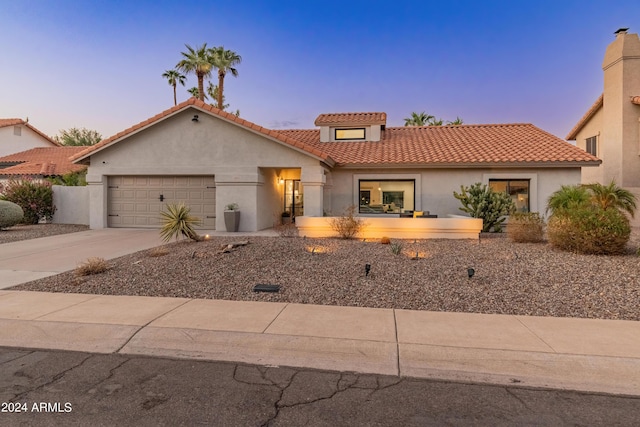 mediterranean / spanish-style home featuring a garage