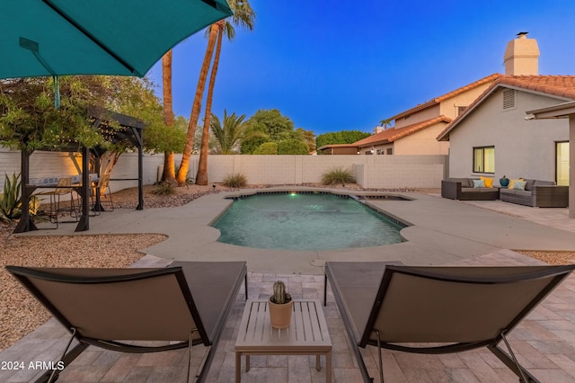 view of swimming pool featuring a patio, pool water feature, and an outdoor living space