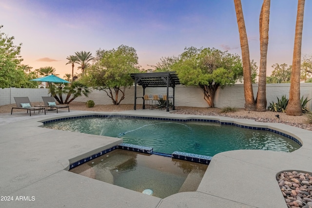 pool at dusk with a pergola and a patio area