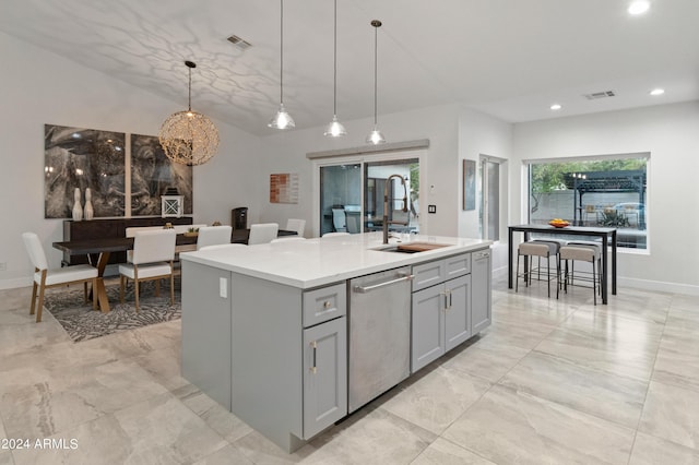 kitchen featuring dishwasher, gray cabinetry, hanging light fixtures, an island with sink, and sink