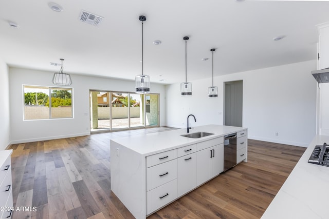 kitchen with visible vents, light countertops, stainless steel dishwasher, wood finished floors, and a sink