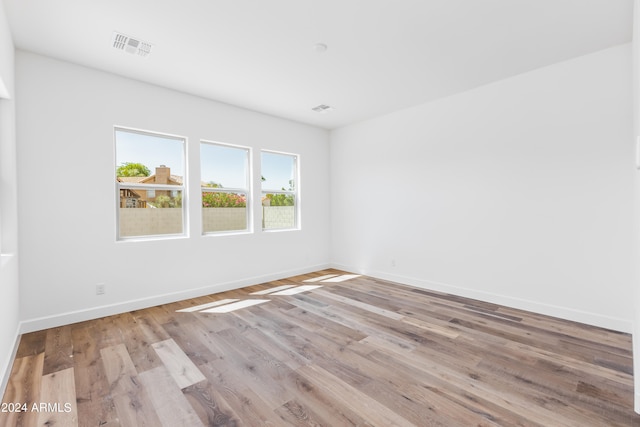 unfurnished room with light hardwood / wood-style flooring