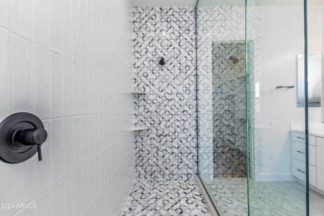 bathroom with vanity and a shower with shower door