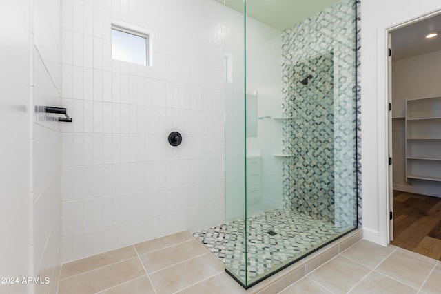 full bath featuring tile patterned floors and a walk in shower