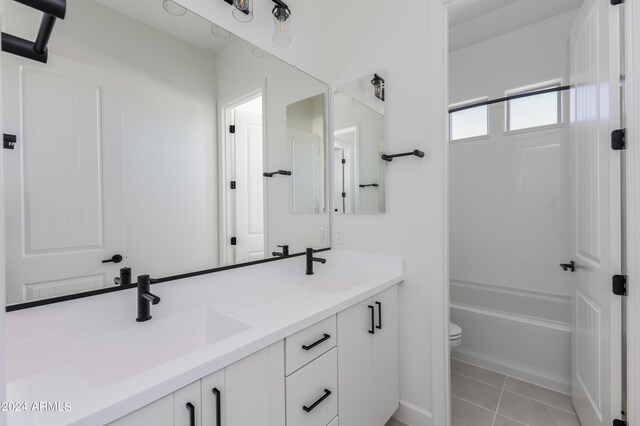 full bathroom with vanity, toilet, tile patterned floors, and  shower combination