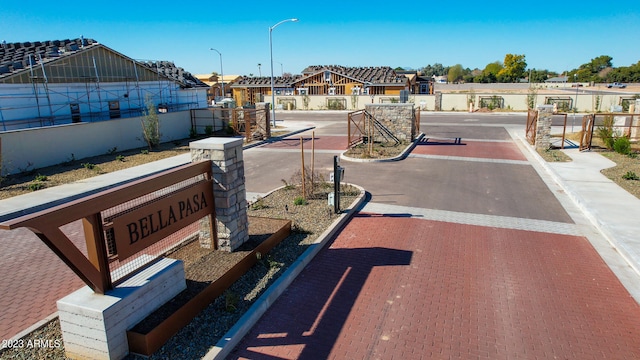 view of street featuring a residential view, street lights, and curbs