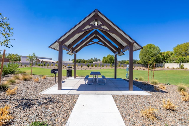 view of home's community featuring a gazebo, a yard, fence, and a patio